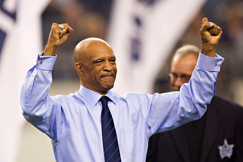 Drew Pearson of the Dallas Cowboys signals to the crowd after being inducted into the Ring of Honor at halftime during a game against the Seattle Seahawks at Cowboys Stadium on November 6, 2011 in Arlington, Texas.