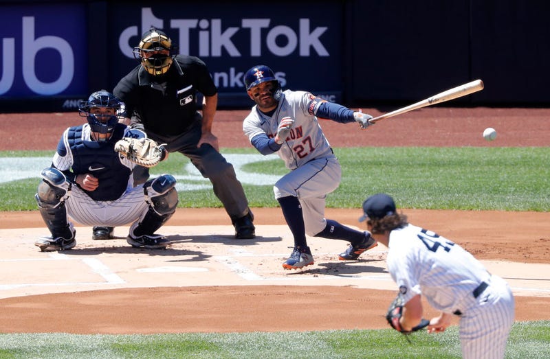Jose Altuve #27 of the Houston Astros singles during the first inning against Gerrit Cole #45 of the New York Yankees at Yankee Stadium on May 06, 2021 in New York City.