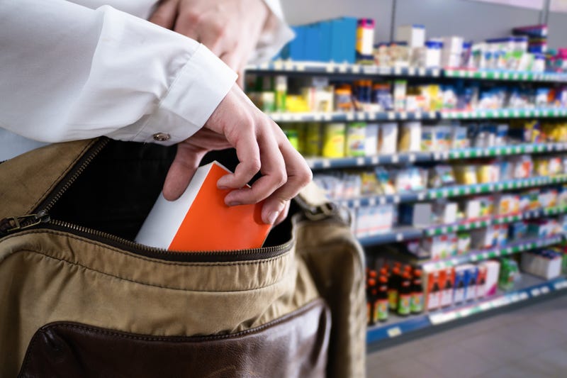 person putting item in bag at supermarket