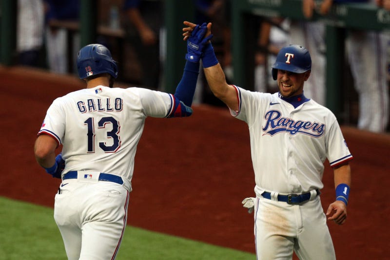 Joey Gallo #13 is greeted by Nate Lowe #30 of the Texas Rangers after a two-run home run by Gallo in the fourth inning against the Seattle Mariners at Globe Life Field on May 08, 2021.