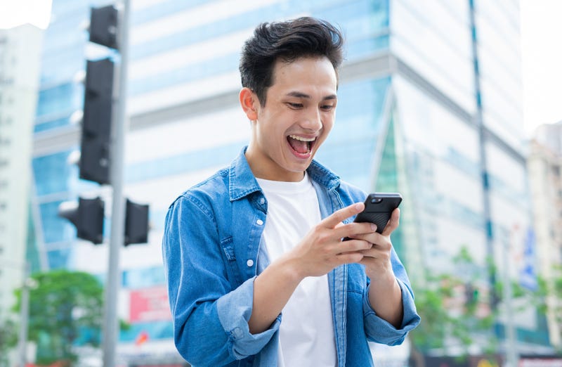 man smiling at his phone