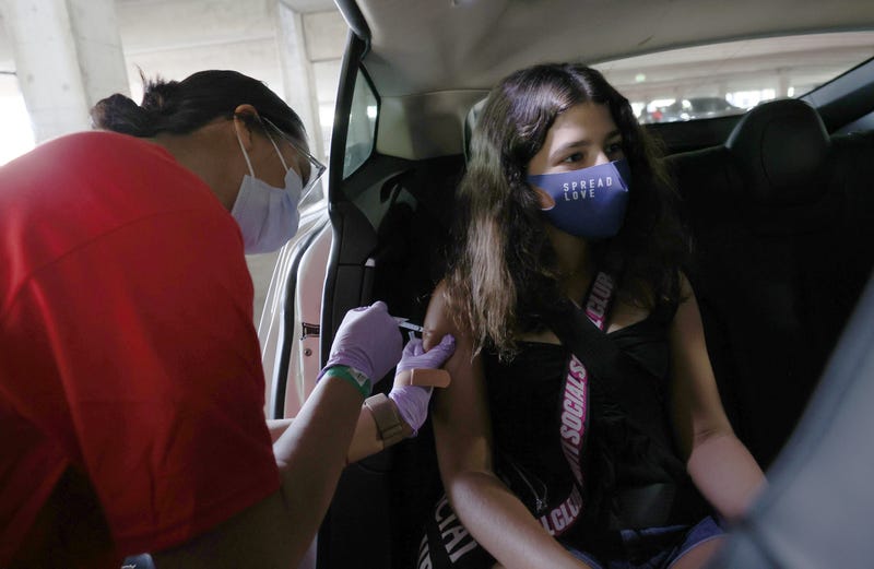 Willow Basta, 12, receives a Pfizer COVID-19 vaccination at a drive-thru vaccine clinic on May 13, 2021 in San Jose, California.
