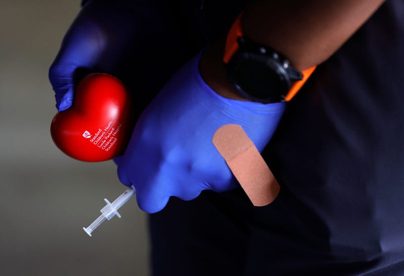A nurse with Stanford Children's Health holds a syringe and a stress ball before delivering a Pfizer COVID-19 vaccination at a drive-thru vaccine clinic on May 13, 2021 in San Jose, California.