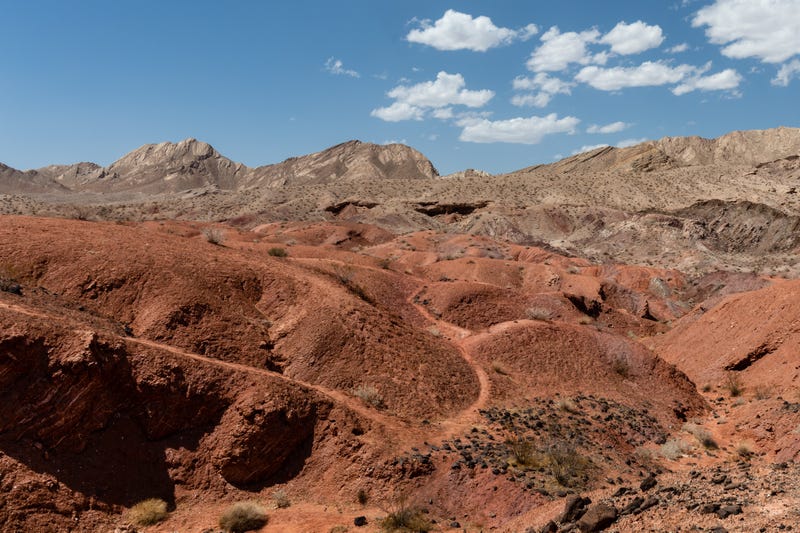 A trail winds through the desert landscape toward distant mountains along the Northshore Road in the Lake Mead National Recreation Area, Nevada