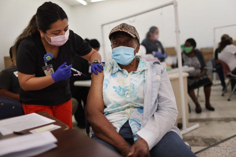 Anna Mendez, LPN, administers a Moderna COVID-19 vaccine to Vern Henderson at a clinic set up by Healthcare Network on May 20, 2021 in Immokalee, Florida.