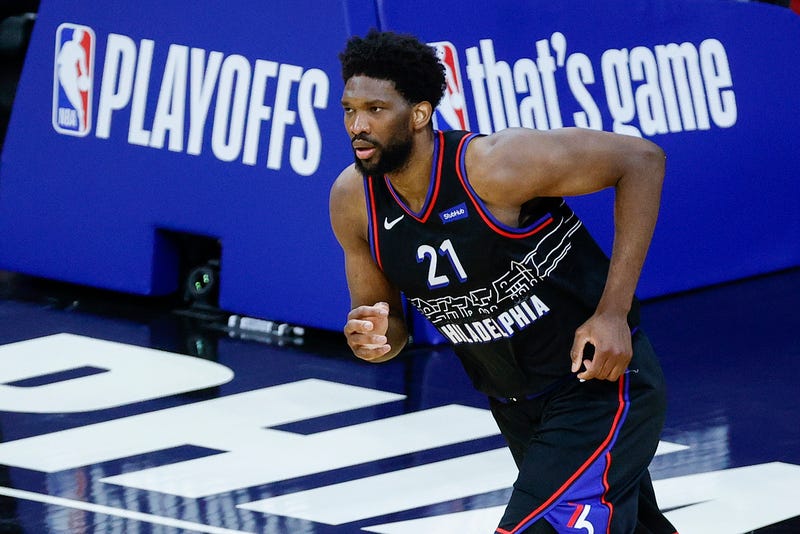 Sixers star Joel Embiid running up the court.