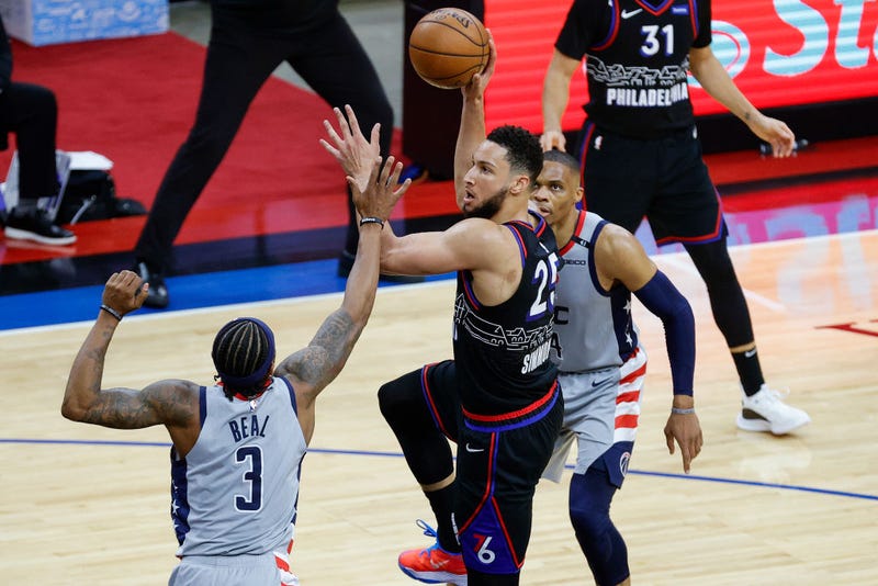 PHILADELPHIA, PENNSYLVANIA - MAY 23: Ben Simmons #25 of the Philadelphia 76ers shoots over Bradley Beal #3 of the Washington Wizards during the third quarter during Game One of the Eastern Conference first round series at Wells Fargo Center on May 23, 2021 in Philadelphia, Pennsylvania. 