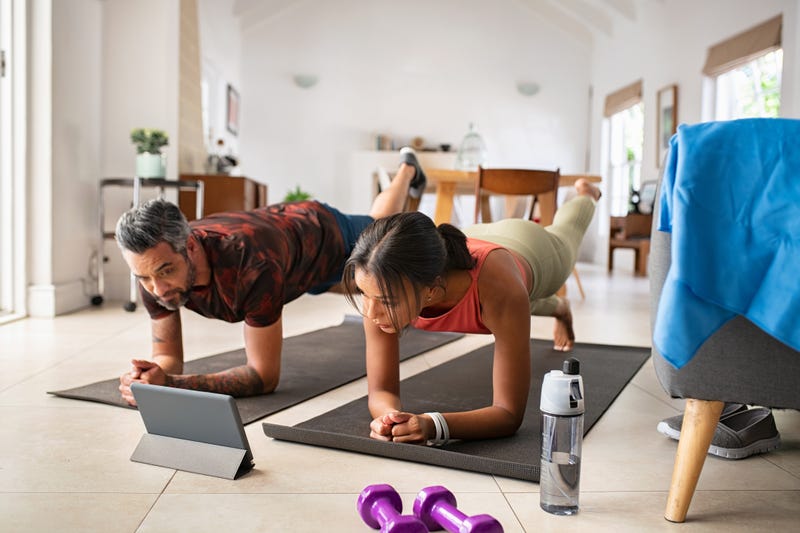 Couple working out with tablet stock photo. 