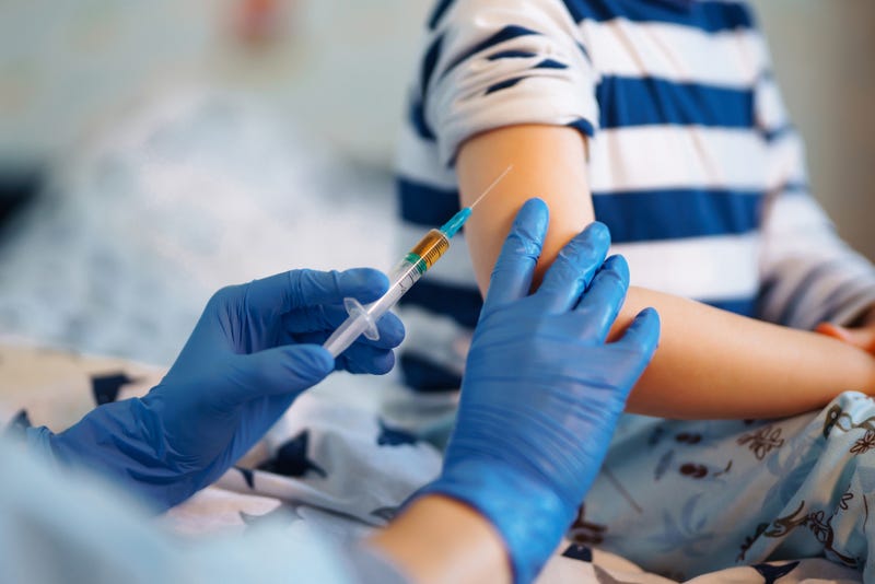 Child receiving a vaccine.