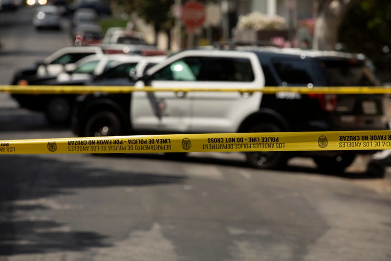 police cars behind caution tape