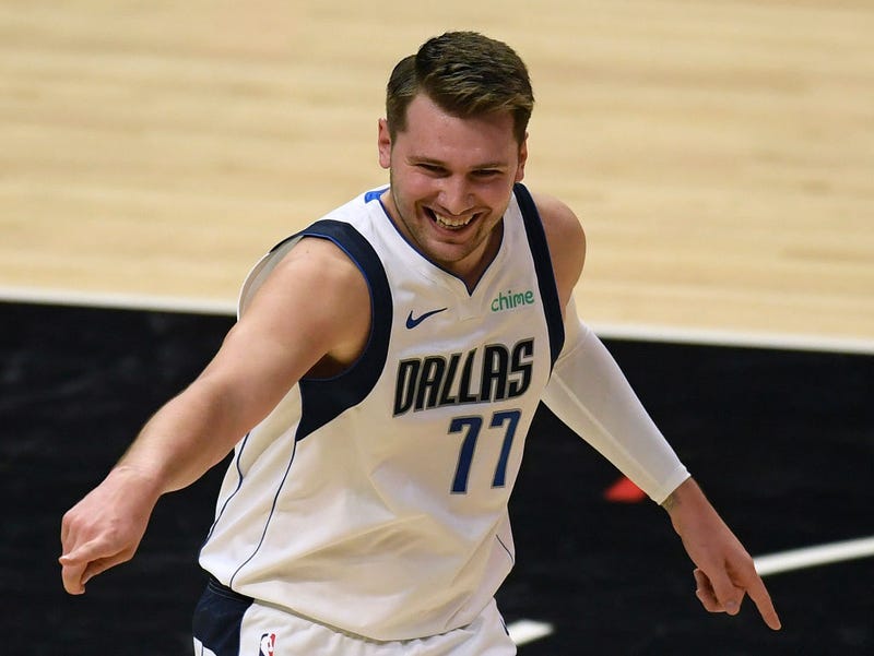 Luka Doncic #77 of the Dallas Mavericks reacts with fans in celebration of a Mavericks basket in the first quarter against the LA Clippers during game two of the Western Conference first round series at Staples Center on May 25, 2021 in Los Angeles, California.
