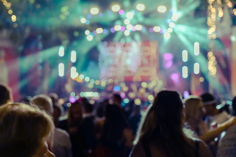 stock image of a music fest, blurry, stage, audience