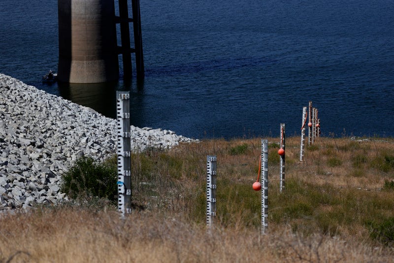 Water depth markers stand on the dry banks of Eastman Lake on May 26, 2021 in Raymond, California.
