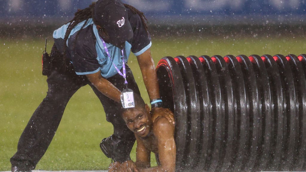 WATCH: Streaker at Nationals game runs, slides on tarp during rain delay