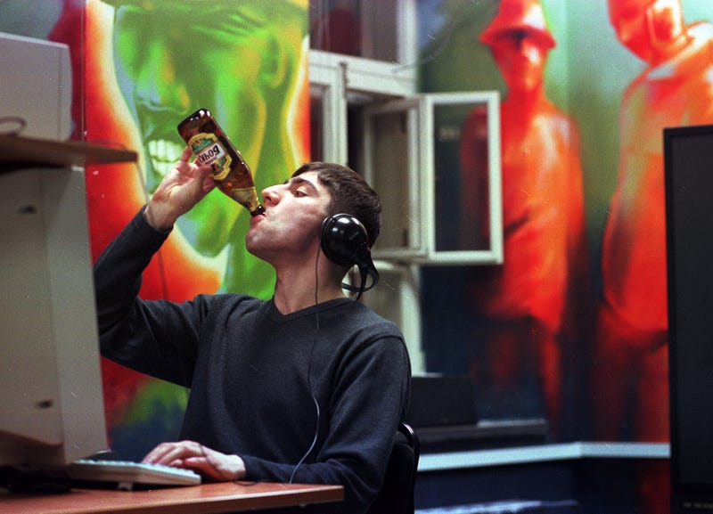 A Russian man drinks a beverage while surfing the web at the Internet club "Nirvana" December 19, 2000 in downtown Moscow, Russia.
