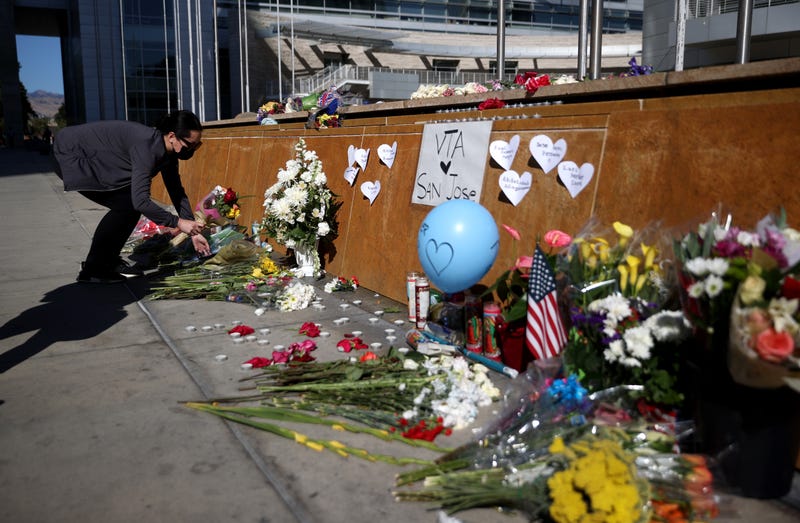 A mourner leaves flowers at a memorial for the nine victims of a shooting at the Santa Clara Valley Transportation Authority (VTA) light rail yard on May 27, 2021 in San Jose, California