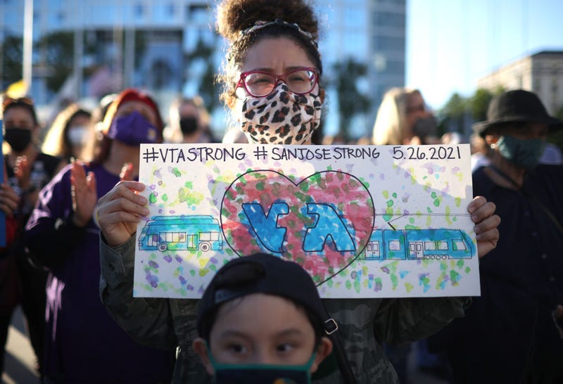 A mourner holds a sign during a vigil to honor the nine Santa Clara Valley Transportation Authority (VTA) light rail yard shooting victims at San Jose City Hall on May 27, 2021 in San Jose, California. 