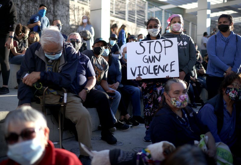 A mourner holds a sign during a vigil for the nine Santa Clara Valley Transportation Authority (VTA) light rail yard shooting victims at San Jose City Hall on May 27, 2021 in San Jose, California. 