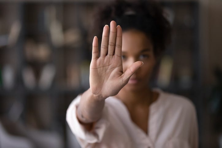 Woman holding her hand up. 