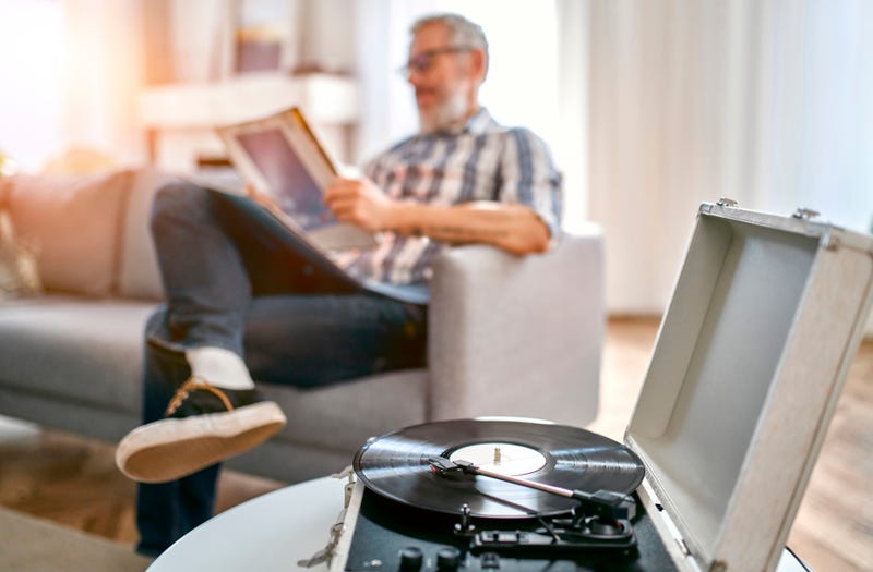  guy listening to music on a record player