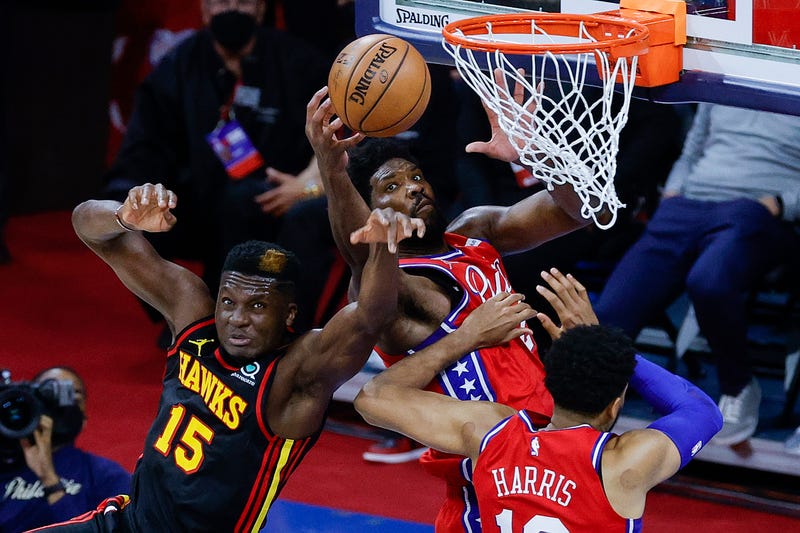 Atlanta's Clint Capela tangles with Joel Embiid during the fourth quarter during Game One of the Eastern Conference second round series at Wells Fargo Center on June 6, 2021.