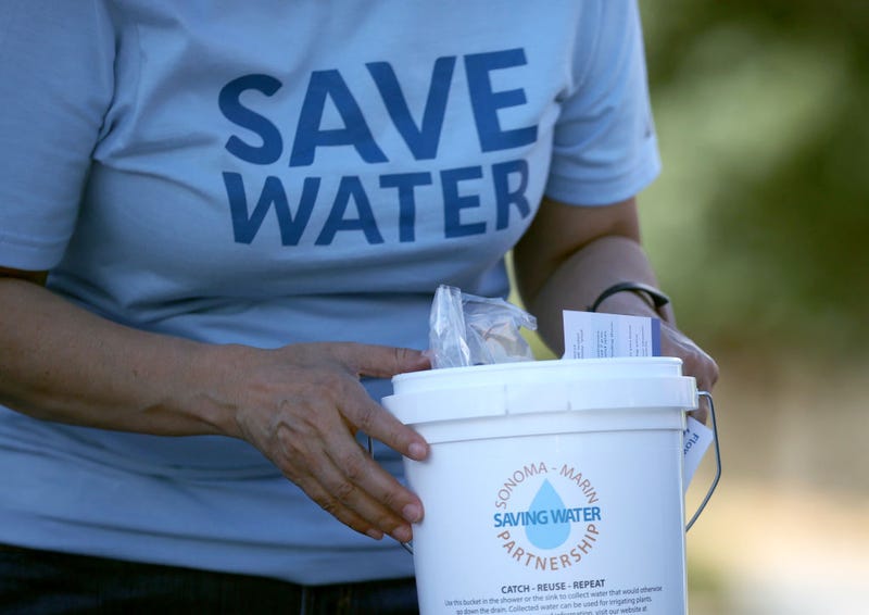 Jeanne Mariani-Belding with the Marin Municipal Water District (MMWD) prepares to hand out a bucket filled with information on the drought and water saving tools during a "Drought Drive Up" event at the MMWD headquarters on June 12, 2021 in Corte Madera, California.