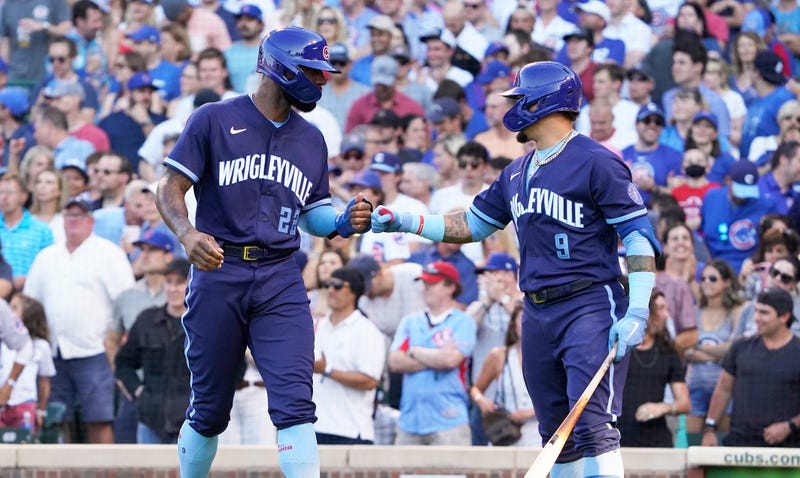 Jason Heyward #22 of the is greed by Javier Baez #9 of the Chicago Cubs after scoring against the St. Louis Cardinals during the second inning at Wrigley Field on June 12, 2021 in Chicago, Illinois.