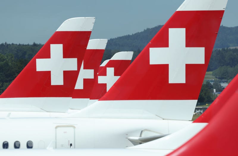 Passenger planes of Swiss airlines stand on the tarmac at Zurich Airport.