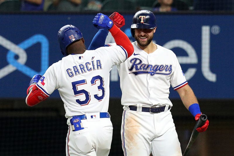 Adolis Garcia #53 of the Texas Rangers celebrates his sixth inning home run with Joey Gallo #13 of the Texas Rangers against the Oakland Athletics at Globe Life Field on June 23, 2021 in Arlington, Texas.