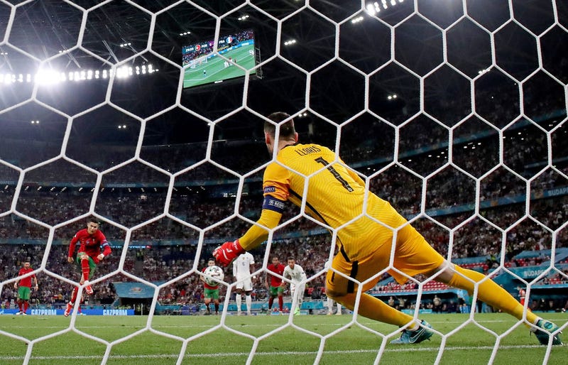 Cristiano Ronaldo of Portugal scores his sides first goal past Hugo Lloris if France from the penalty spot during the UEFA Euro 2020 Championship Group F match between Portugal and France at Puskas Arena on June 23, 2021 in Budapest, Hungary