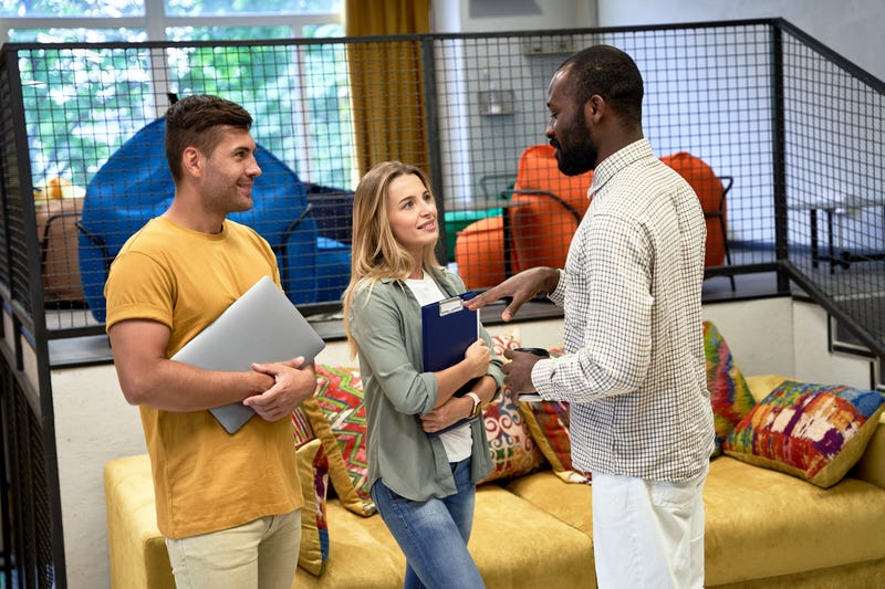 Black man talks to colleagues in office
