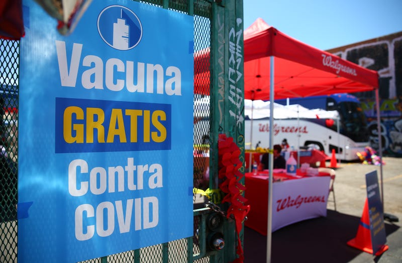 A sign written in Spanish promotes free COVID-19 vaccination doses outside a Walgreens mobile bus clinic on June 25, 2021 in Los Angeles, California.