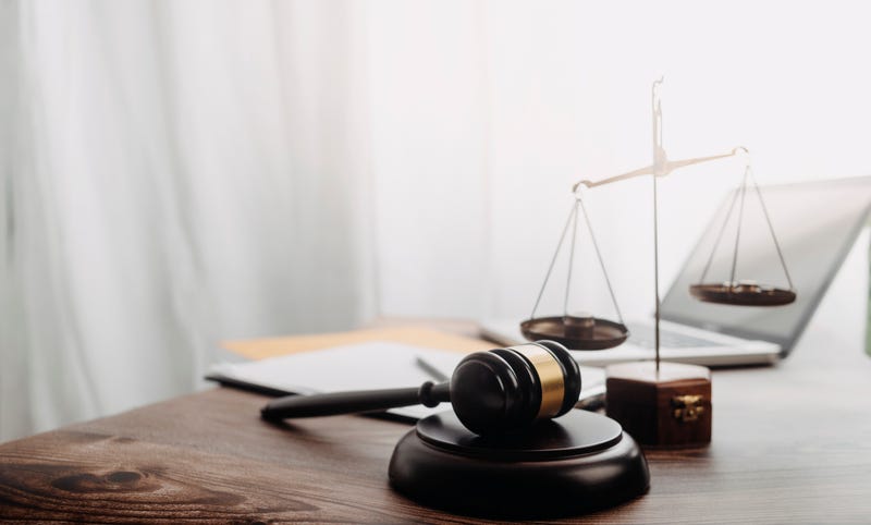 Gavel and scale representing court proceedings. 