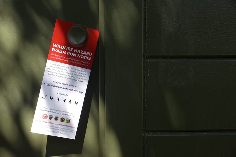 A door tag hangs from a doorknob after inspectors the Marin Wildfire Prevention Authority surveyed a property during a defensible space inspection on June 29, 2021 in Greenbrae, California.