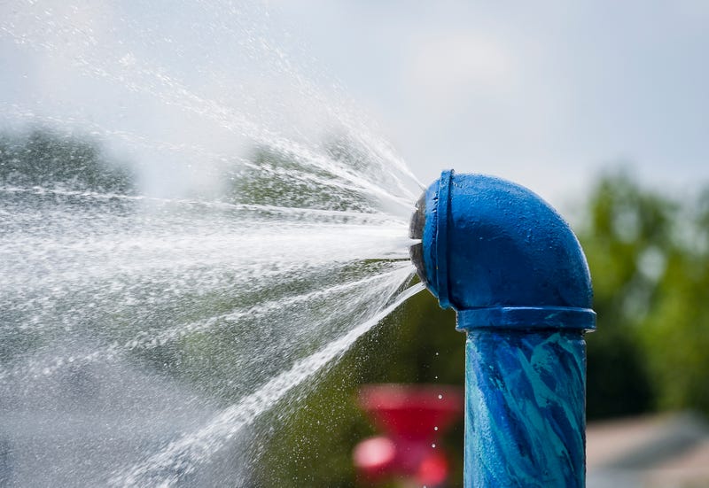 Water sprays out of the sprinkler at a spray park 
