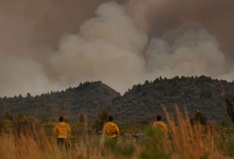 Cal Fire firefighters monitor the Lava Fire as it moves through the area on July 01, 2021 in Weed, California.