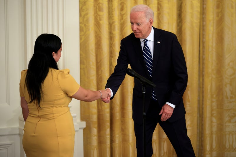 President Biden and a new citizen during a naturalization ceremony at the White House Friday.