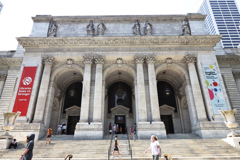 People walk along the stairs of the New York Public Library on July 6, 2021 in midtown Manhattan