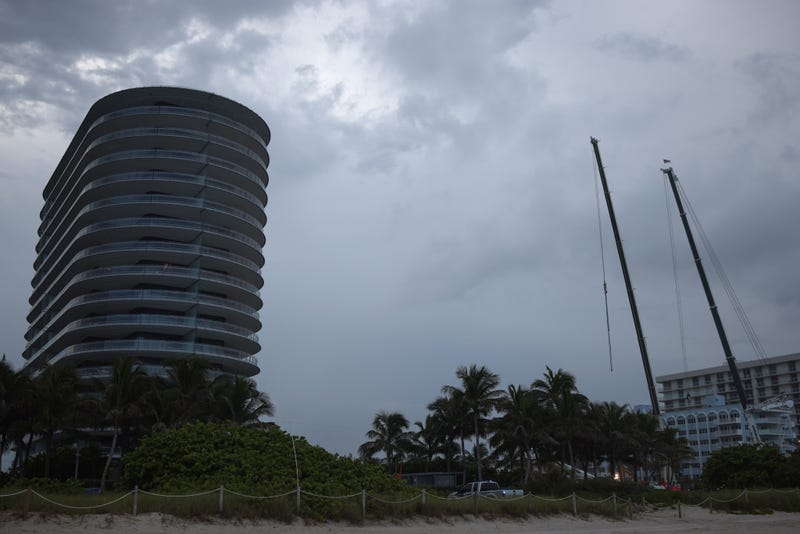 Cranes dig through rubble of the collapsed condo building in Surfside, Florida.