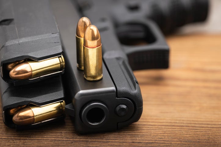 Close up of the muzzle of a gun with multiple bullets loaded
