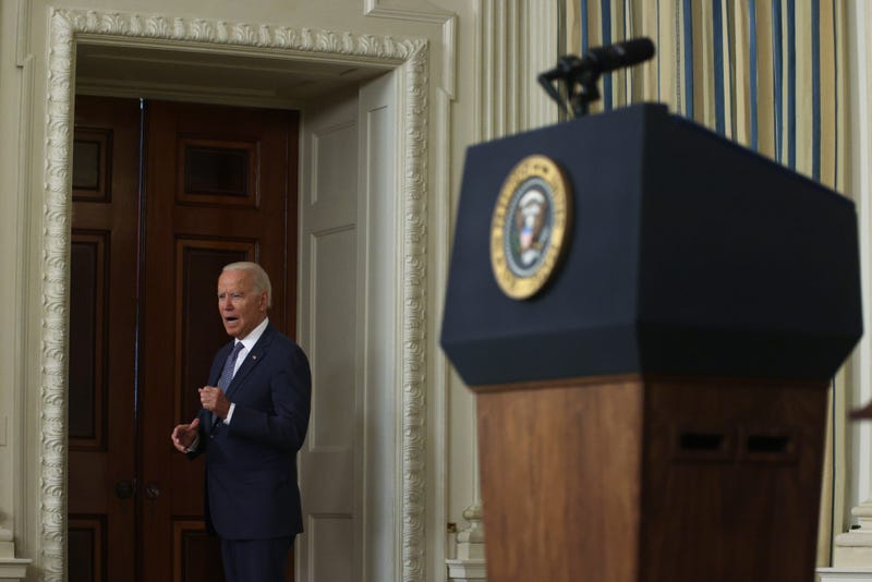President Biden answers reporters questions before leaving the State Dining Room of the White House.