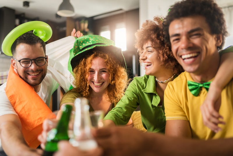 Group Of Young People Having Fun And Drinking Beer Together. Ireland national symbols. St Patrick Da