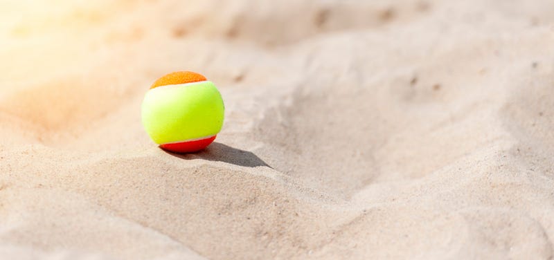 Tennis ball on the beach.