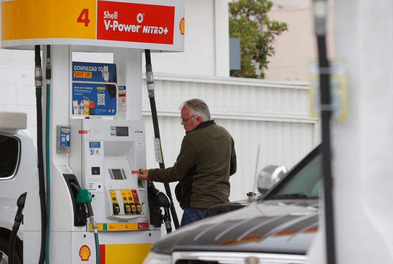 FILE - A customer prepares to pump gas at a Shell station on July 12, 2021 in San Francisco, Calif.
