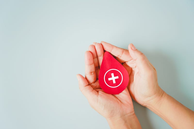 Hand holding blood sign