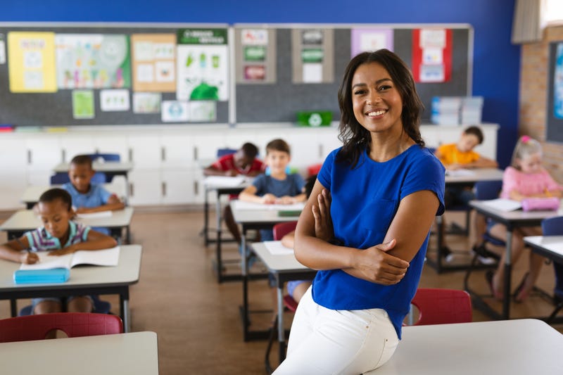 Portrait of African American female teacher smiling in the class at school