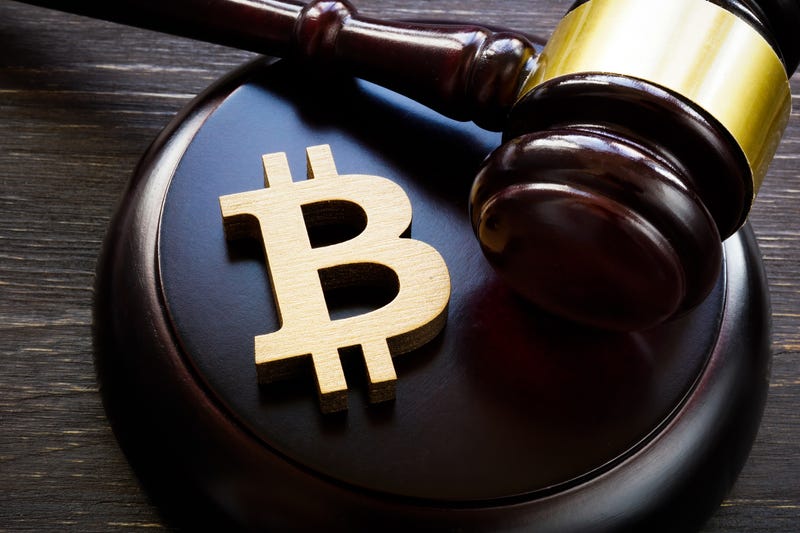 Bitcoin logo on a gavel.