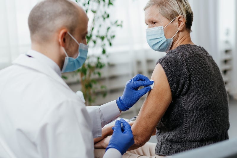 close-up. woman in a protective mask is vaccinated in a medical office.