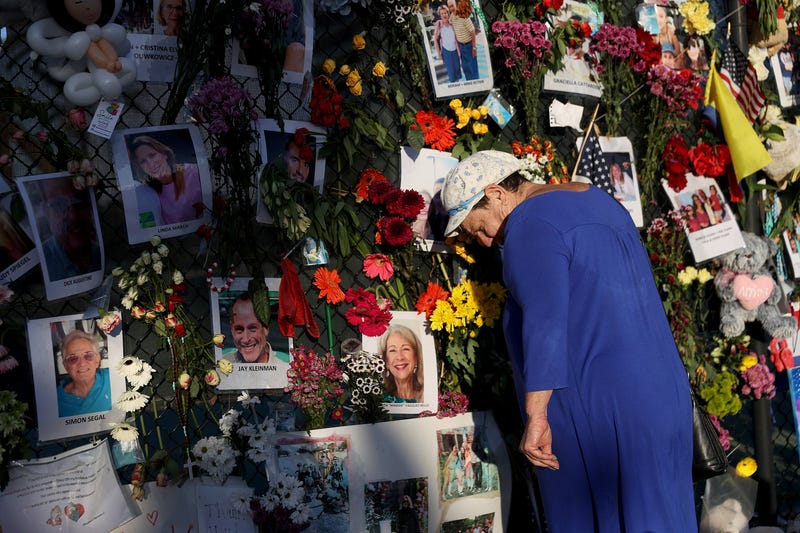 A memorial bearing photos of some of the victims of the Surfside condo collapse.