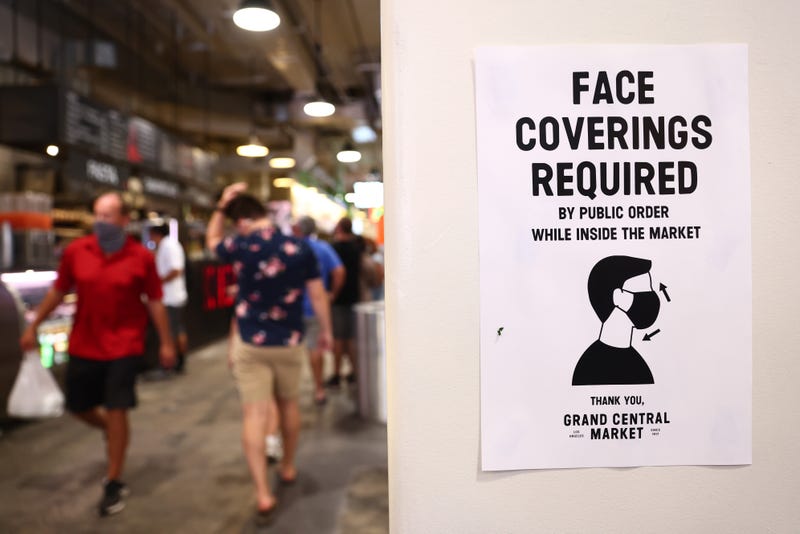 A sign is posted about required face coverings in Grand Central Market on July 19, 2021 in Los Angeles, California. 